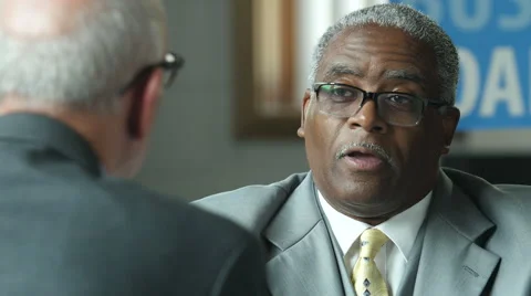 Mature black business banker meeting with a senior client Stock Footage