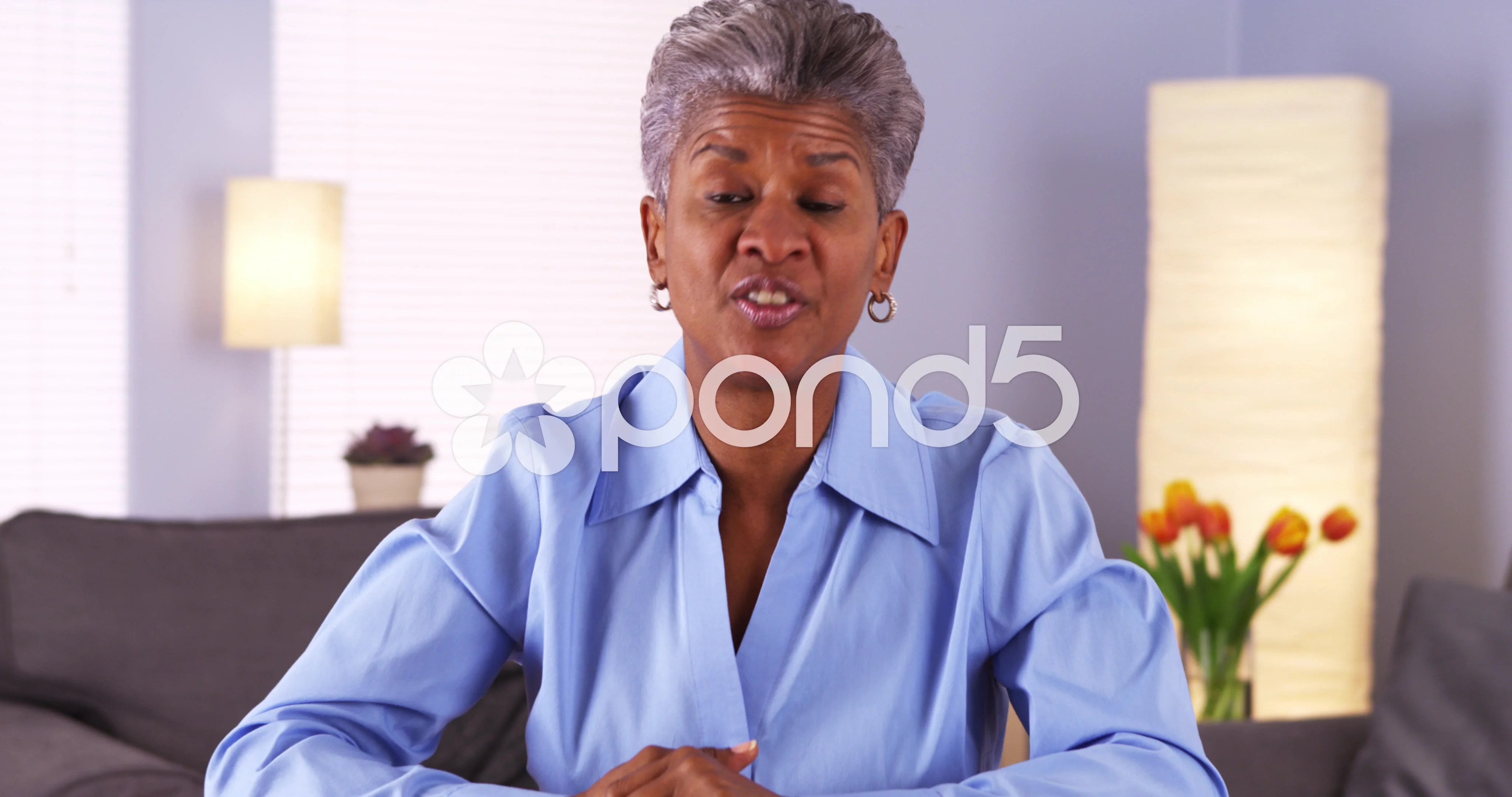 Mature Black woman talking to camera