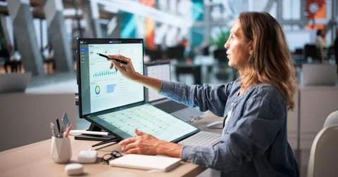 Mature Business Manager Using Touchscreen Computer To Analyze Integrated ERP  Fotos Stock