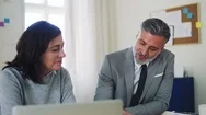 Mature Businessman And Businesswoman Working Together In Office, Talking. Stock Footage
