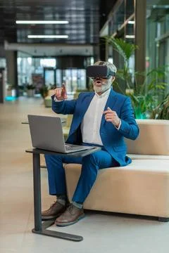 Mature businessman software developer using headset app making presentation in 写真素材