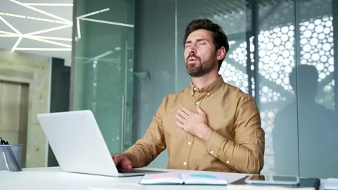 Mature businessman taking a work break to practice deep breathing while sitting  Stock Footage 342019928