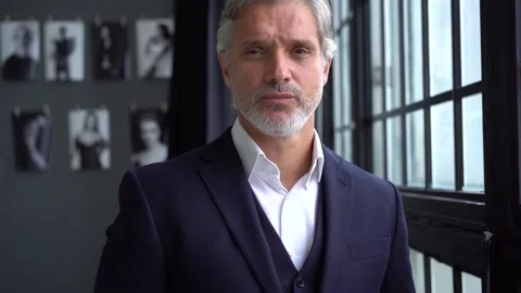 Mature businessman thinks about future projects while standing near window. Stock Footage 140643746