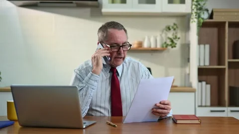 Mature Businessman using laptop while sitting at home. man sitting in kitch.. Stock Footage 313460724