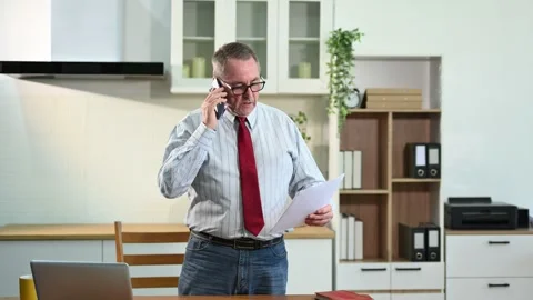 Mature Businessman using laptop while sitting at home. man sitting in kitch.. Stock Footage 313460725