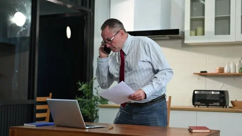Mature Businessman using laptop while sitting at home. man sitting in kitch.. Stock Footage 313460731
