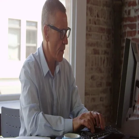 Mature Businessman Working On Computer In Office Shot On R3D Stock Footage