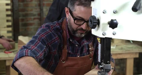 Mature Cabinet Maker Creates a Cabrioli Leg Using Bandsaw Stock Footage 74491028