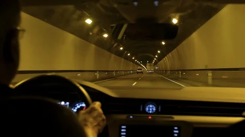 Mature Car Driver driving through a Tunnel Stock Footage 90769902