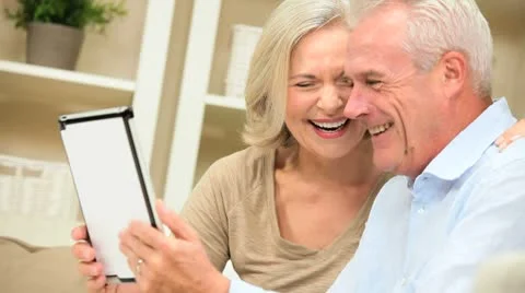Mature Caucasian Couple Using a Wireless Tablet at Home Stock Footage 8975139