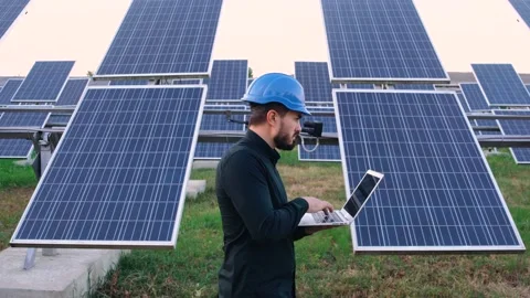 Mature Caucasian engineer using laptop to control solar panel batteries. Stock-Footage 140203900