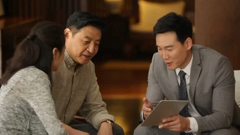 Mature Chinese couple talking with financial advisor ,HD Stock Footage