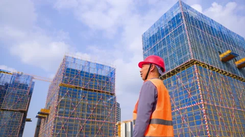 Mature construction man worker engineer wearing a red hard hat, orange safety Stock Footage 345859210