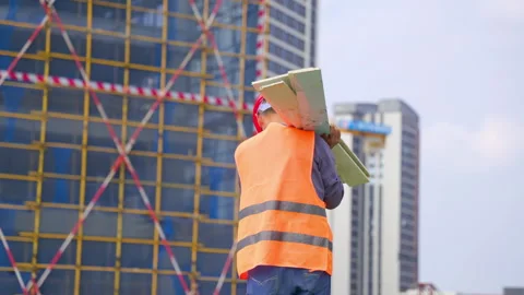 Mature construction man worker engineer wearing red hard hat, orange safety Stock Footage 345860064