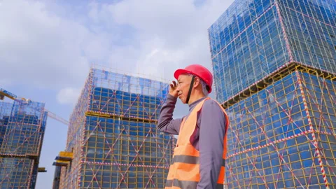 Mature construction man worker engineer wearing a red hard hat, an orange Stock Footage 345862129