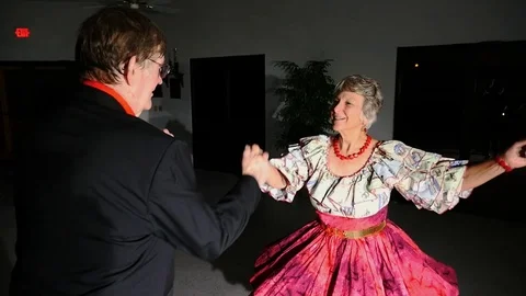 A mature couple ballroom dancing in the spotlight Stock Footage