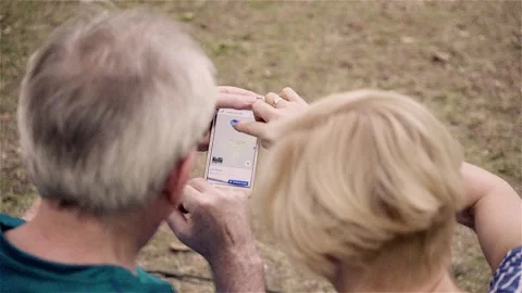 Mature couple checking map on smartphone Stock Footage 88428079