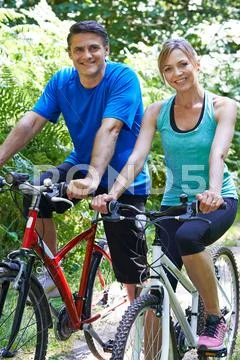 Mature Couple On Cycle Ride In Countryside Stock Photos