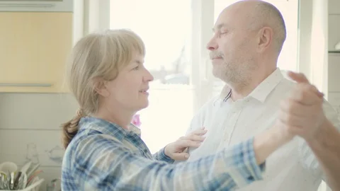 Mature Couple Dancing In The Kitchen. Stock Footage 128844437