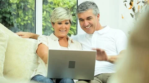 Mature Couple Having Online Webchat at Home Stock Footage 8688564