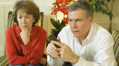 Mature couple looking at something scary on tv Stock Footage