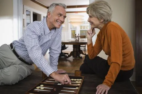 Mature couple playing backgammon Stock Photos