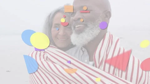 Mature couple pulling blanket closer on shore, overlay starting and layering Stock Footage 333975392