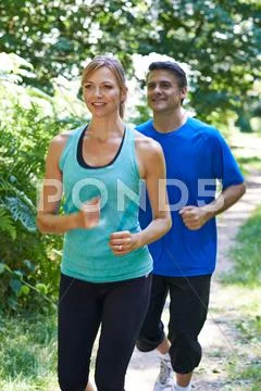 Mature Couple Running In Countryside Stock Photos