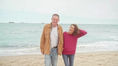 Mature couple smiling at camera in beach Stock Footage 272447341