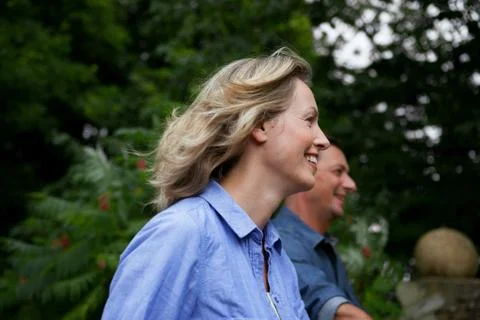 Mature couple smiling while strolling in garden Fotos Stock