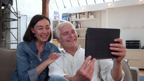 Mature couple using a digital tablet Stock Footage 81247977