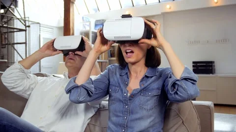 Mature couple using virtual reality headset in living room Video stock 81248103