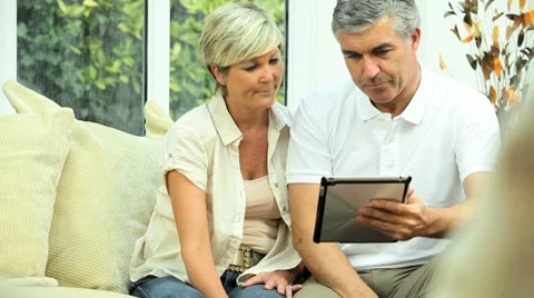 Mature Couple Using Wireless Tablet for Finances Stock Footage 8689168