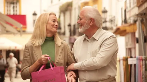 Mature couple walking in town Stock Footage 43610341
