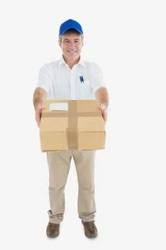 Mature delivery man handing package Stock Photos