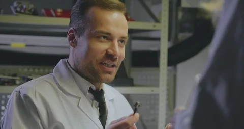 Mature engineer instructing young assistant Stock Footage 112060311