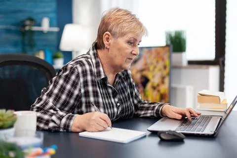 Mature entrepreneur taking notes on notebook Stock Photos