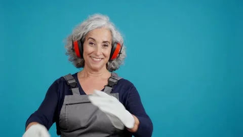 Mature female carpentry worker with tools and work uniform Видео 229547647