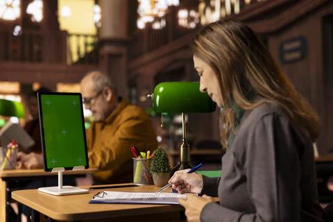 Mature focused student writes a transcript next to copy space display 스톡 사진