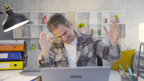 Mature home office worker using laptop with excitement and joy is dancing Stock Footage 230947649