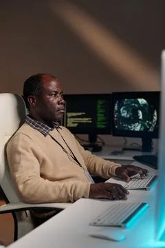 Mature IT support manager decoding data Stock Photos