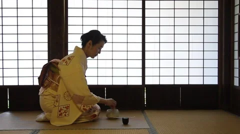 Mature Japanese woman in a kimono preparing green tea in a traditional house Stock Footage