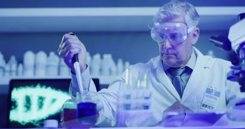 Mature laboratory scientist using a pipette dropper to fill test monkeypox tubes Stock Footage 200458918