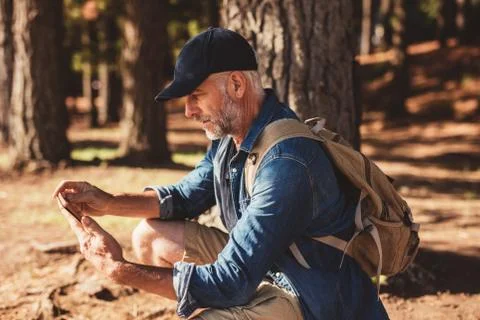 Mature male hiker using digital tablet for navigation Stock Photos