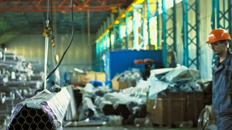 Mature male worker posing with a stack of steel pipes Stock Footage 89769033