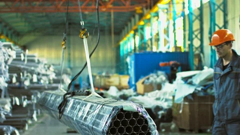 Mature male worker posing with a stack of steel pipes Stock Footage 89769165