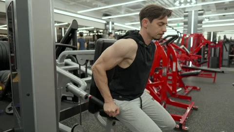 Mature man in 40s Doing Lower Chest Muscles Exercise in Dips Machine at Stockbeeldmateriaal 254680273