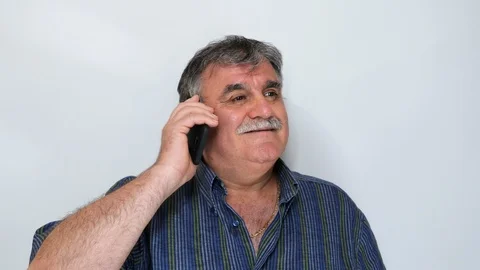 Mature man (50s-60s) using smartphone on white background. Filmed in 4K Video stock 115446097