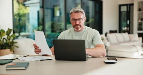 Mature, man and documents with laptop for finance, budget planning or checking Video stock 335527015