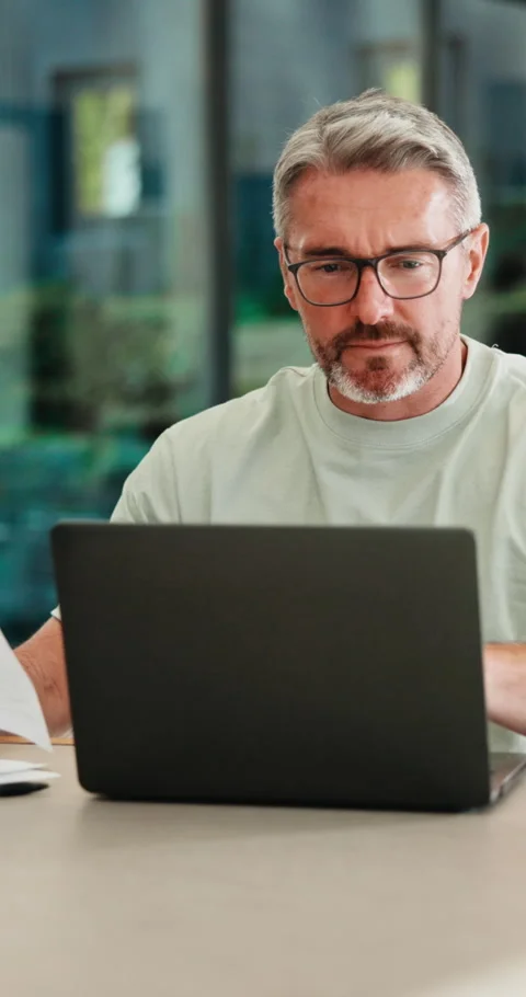 Mature, man and documents with laptop in home for finance, budget planning or Stock Footage 335875192